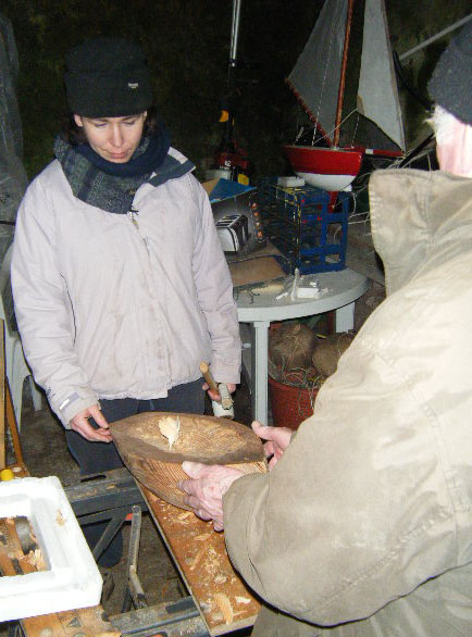 Loughie inspects the gouging of Marianne's hull.